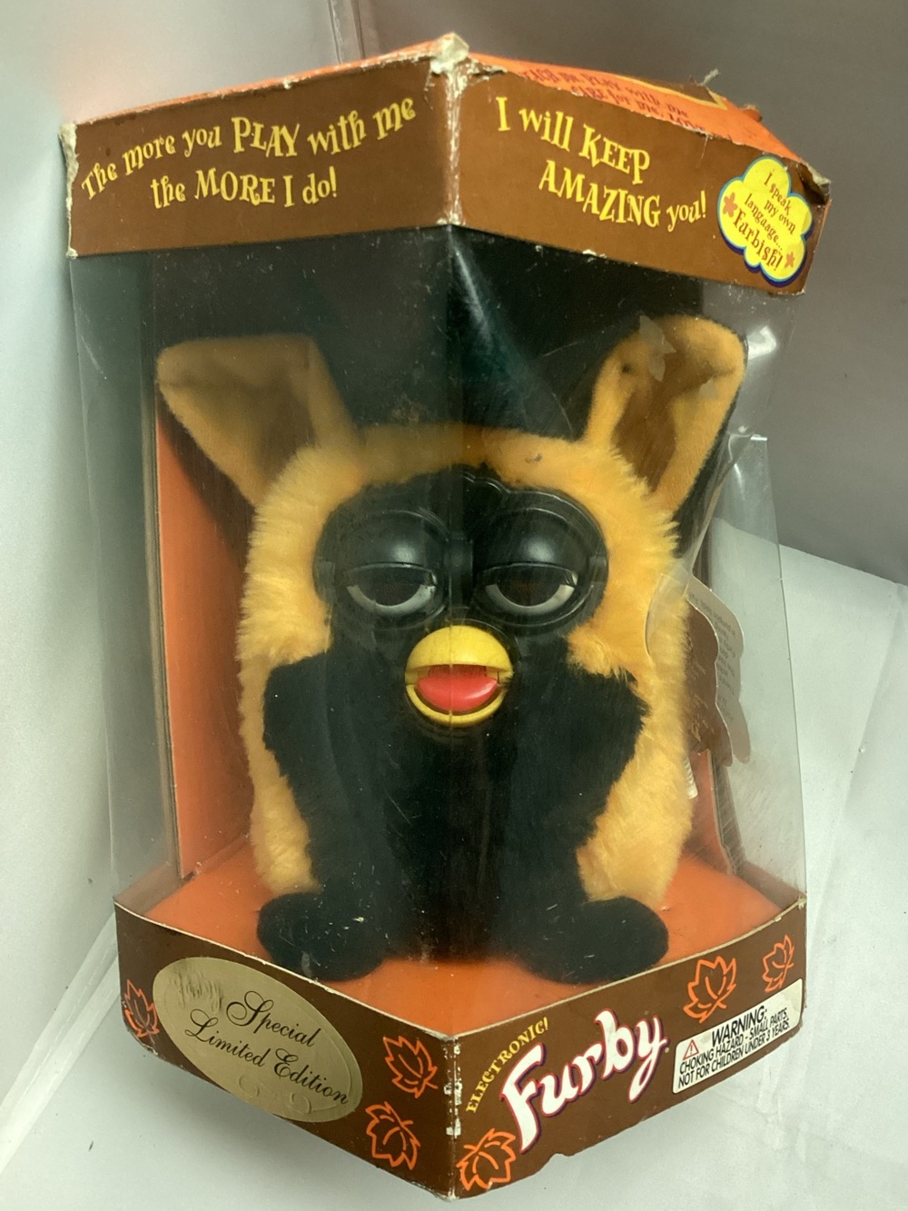 1999 orange and black Furby—specifically the special edition "Autumn Witch"